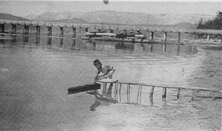 Young Jim Spilsbury playing near the dock circa 1913 
(Source: Spilsbury's Coast by Howard White and Jim Spilsbury, Harbour Publishing, 1987, www.harbourpublishing.com)
